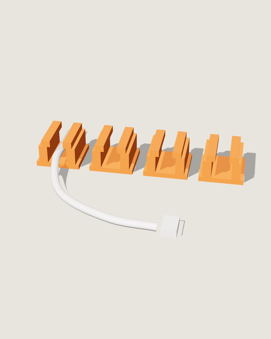 Vier oranje kabelclips met een laadkabel